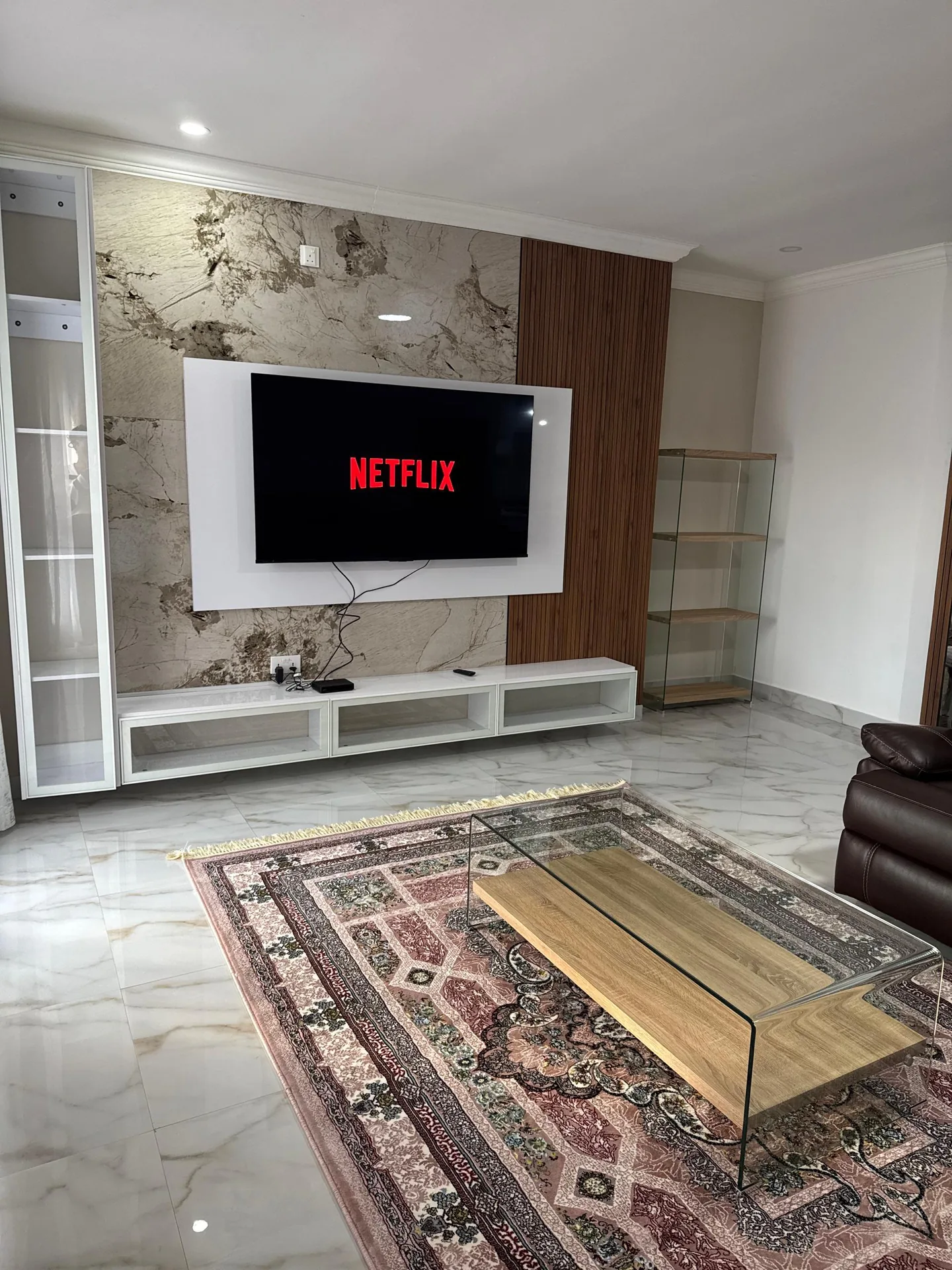 Living room with wall-mounted TV and wood panelling